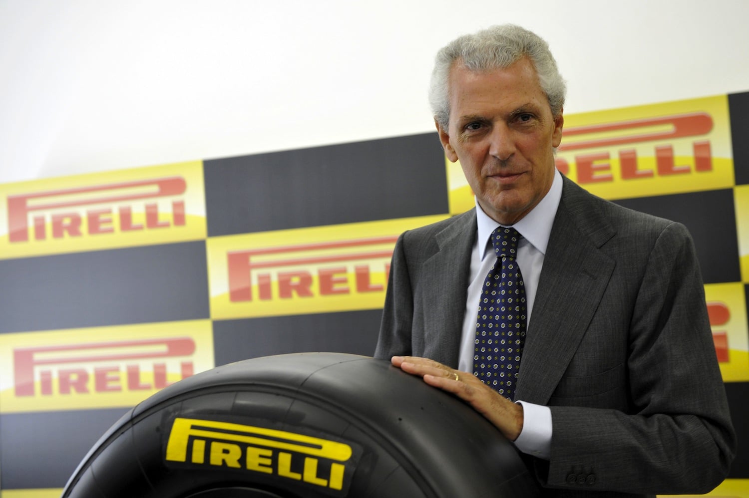 chairman of the Pirelli Group, Marco Tronchetti Provera poses with a Formula One tyre in Milan on June 24, 2010. Italian tyre manufacturer Pirelli has clinched an exclusive three-year deal to supply tyres to Formula One teams from next year, the sport's governing body FIA announced. AFP PHOTO / GIUSEPPE CACACE