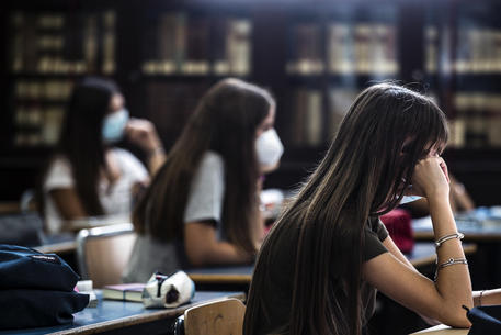 Students wear protective masks in their classroom at the former library at the Visconti High School during the Coronavirus Covid-19 pandemic emergency in Rome, Italy, 15 September 2020. ANSA/ANGELO CARCONI