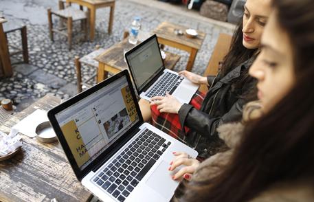epa04134573 Two Turkish women try to get connected to the twitter web site with their laptops at a cafe in Istanbul, Turkey 21 March 2014. The social media site Twitter was blocked in Turkey early on 21 March 2014, amid an internet crackdown in the country. Some users said they could not load the site, while others were being redirected to an official website saying a court order was applying 'protection measures.'The move came just hours after Turkish Prime Minister Recep Tayyip Erdogan promised to 'root out' Twitter, after pushing through new legislation last month which allows authorities to shut down websites and track users' browsing histories.  EPA/TOLGA BOZOGLU