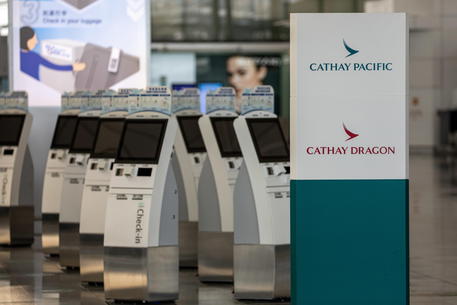 epa08760686 Smart check-in kiosks are left unused in the departure hall at Hong Kong International Airport in Hong Kong, China, 21 October 2020. Hong Kong's flag carrier Cathay Pacific Airways announced that it will eliminate 8,500 job posts, with 5,900 staff made redundant, and one of its regional airlines, Cathay Dragon, will be shut down under a global 2.2 billion Hong Kong dollar (284 million US dollar) restructuring to cope with the pandemic fallout. Cathay Pacific's daily passenger volume collapsed 99 percent because of the coronavirus and COVID-19 disease pandemic.  EPA/JEROME FAVRE