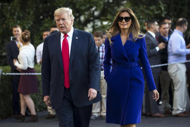 epa06306197 US President Donald J. Trump (L) with First Lady Melania Trump (R) walk to deliver remarks to the news media prior to boarding Marine One on the South Lawn of the White House in Washington, DC, USA, 03 November 2017. President Trump is departing the White House on a multi country Asia tour.  EPA/SHAWN THEW