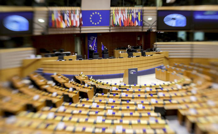 epa08757505 A picture taken with a lensbaby lense shows a general view over parliamentary ushers preparing the Hemicycle of the European Parliament prior a plenary session, in Brussels, Belgium, 19 October 2020. The plenary session that was scheduled to be held in Strasbourg will take place in a scaled-down, mostly virtual format in Brussels due to the ongoing coronavirus pandemic.  EPA/OLIVIER HOSLET