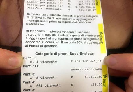 The owner of the Marino?s bar, Sara Poggi, shows the receipt of the ticket where it was bet the winning ticket of the 