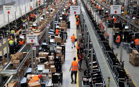 epa06898242 (FILE) - A general view of employees working at the new Amazon Logistic and Fulfillment Center in Dortmund, Germany, 14 November 2017 (re-issued 19 July 2018). Reports on 19 July 2018 state Amazon crossed the 900 billion USD line on 18 July after its shares saw a rise of 0.8 per cent to a record 1,858.88 USD to become only the second company after Apple to be valued that high.  EPA/FRIEDEMANN VOGEL