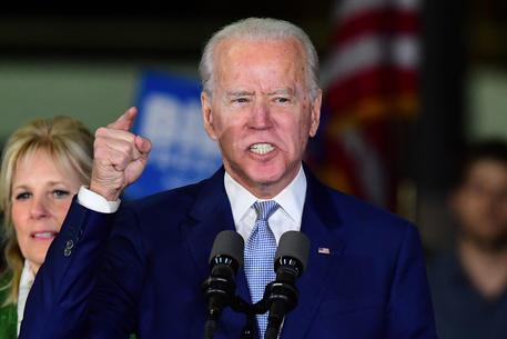 (FILES) In this file photo taken on March 3, 2020 Democratic presidential hopeful former Vice President Joe Biden, flanked by his wife Jill, addresses a Super Tuesday event in Los Angeles. - A resurgent Joe Biden seized the momentum in the race to become the Democratic challenger to President Donald Trump with a string of Super Tuesday victories, including key prize Texas, against rival Bernie Sanders.  Sanders, a 78-year-old leftist who wants to reshape America's economy, had been the clear leader and was looking for a knock-out blow on the most consequential voting day on the primary calendar. (Photo by FREDERIC J. BROWN / AFP)
