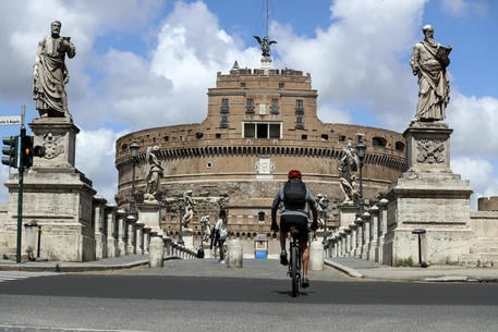 A man on a bike passes by Santà•Angelo Bridge during the coronavirus lockdown in Rome, Italy, 29 April 2020. ANSA/RICCARDO ANTIMIANI