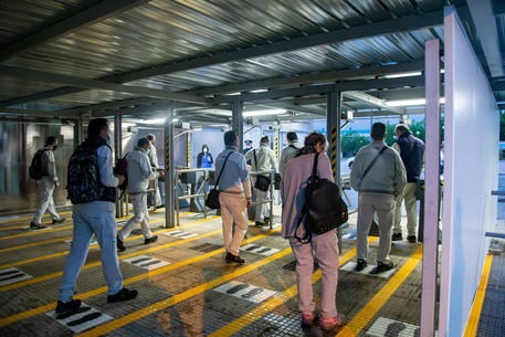 With the first shift at 6.00 a.m., work for the seven thousand employees of the FCA factory in San Nicola di Melfi, near Potenza, southern Italy, returned to full capacity during phase 2 of the coronavirus emergency, 21 May 2020. In front of the gates, in the rain, the workers entered the factory wearing protective face masks, keeping the safety distances and were subjected to body temperature measurement. ANSA/TONY VECE