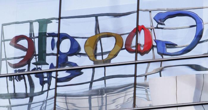 The Google logo is seen reflected on glass windows of a building opposite the Google headquarters office in Beijing, China, 23 March 2010. Google said 22 March it will shift its search engine for China off the mainland. Visitors to Google.cn were now being redirected to Google's Chinese-language service based in Hong Kong. ANSA/HOW HWEE YOUNG