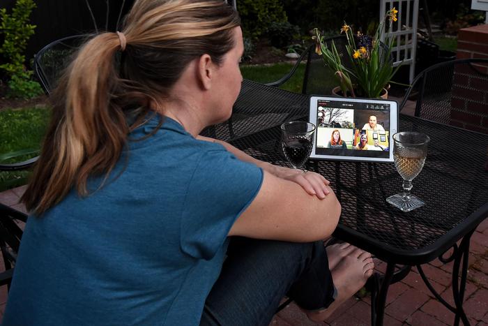 A woman enjoys a virtual happy hour during the coronavirus (Covid-19) crisis on April 8, 2020, in Arlington, Virginia - With bars closing across the United States, people have started meeting online via Houseparty -- one of several group video apps doing a roaring trade during the pandemic. Just this month downloads of Houseparty, which was highly popular with teens a couple of years ago, have surged tenfold to 210,000 per day, according to Apptopia.
Others such as Zoom, used mainly for remote working, and Google Hangouts, Skype and Rave have also seen upticks. (Photo by Olivier DOULIERY / AFP)