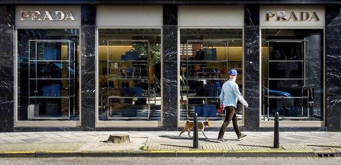 epa04394676 A man walks past the first Dutch Prada boutique in Amsterdam, The Netherlands, 10 September. The new location is designed by Italian architect Roberto Baciocchi.  EPA/KOEN VAN WEEL