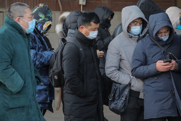 epa08921498 People wearing protective face masks line up to be tested for the COVID-19 coronavirus outside a hospital in Beijing, China, 06 January 2021. China's National Health Commission said it received reports of 32 newly confirmed COVID-19 cases on the Chinese mainland on 05 January 2021 that 23 were locally transmitted and nine were imported. For the locally transmitted cases, 20 were reported in China's Hebei province.  EPA/WU HONG