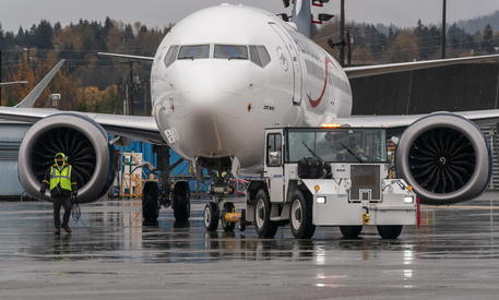 epa08828088 A Boeing 737 MAX is towed toward the runway for a test flight near the company's factory in Renton, Washington, USA, 18 November 2020. The Federal Aviation Administration rescinded its order grounding the plane in March of 2019 following two crashes.  EPA/STEPHEN BRASHEAR