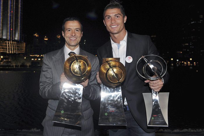 epa03044492 Real Madrid soccer player, Portuguese Cristiano Ronaldo (R), and his manager Jorge Mendes (L), pose with the trophies won during the Globe Soccer Awards ceremony held at Dubai, UAE, 28 December 2011.  EPA/JORGE MONTEIRO
