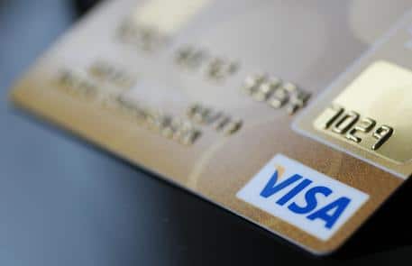 epa04657532 A VISA credit card is placed on a table in Berlin, Germany, 11 March 2015. The European Parliament adopted on 10 March 2015 a regulation capping interchange fees for payments using consumer debit and credit cards and improving competition for all card payments. The Commission estimates that the rules when implemented could lead to a reduction of about 6 billion euros annually in hidden fees for consumer cards.  EPA/JOERGÂ CARSTENSEN