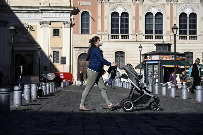 A mother with a baby carriage walks in piazza San Silvestro as few people is seen today in Romeà•s city center, Rome, Italy, 17 November 2020. ANSA/RICCARDO ANTIMIANI