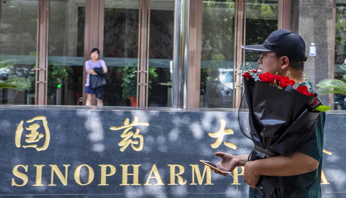 epa08628129 A man walks in front of the Sinopharm headquarters in Shanghai, China, 25 August 2020 (issued 27 August 2020). According to media reports, Sinopharm, major state-owned Chinese pharmaceutical company, plans to have a COVID-19 vaccine on the market by the end of 2020.  EPA/ALEX PLAVEVSKI