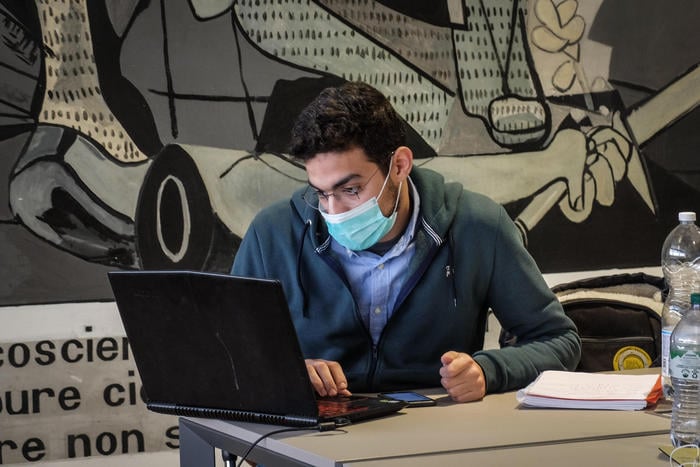 A student of the Milan's  Politecnico University studies wearing a protective in the university library, MIlan, Italy, March 4, 2020. The government has decided to close schools and universities until mid-March to reduce the risk of contagion of the coronavirus. The decision made officially by the government in the afternoon, after the opinion of the technical-scientific committee. Ansa/Matteo Corner