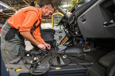 epa07080818 A worker assemble a new electric transporter on the StreetScooter Work XL production line of the US car manufacturer's plant Ford in Cologne-Niehl, Germany, 09 October 2018. The Series production of the StreetScooter Work XL electric transporter, which Ford produces in partnership with StreetScooter GmbH, a subsidiary of Deutsche Post DHL Group, begins at the Ford plant in Cologne-Niehl.  EPA/SASCHA STEINBACH