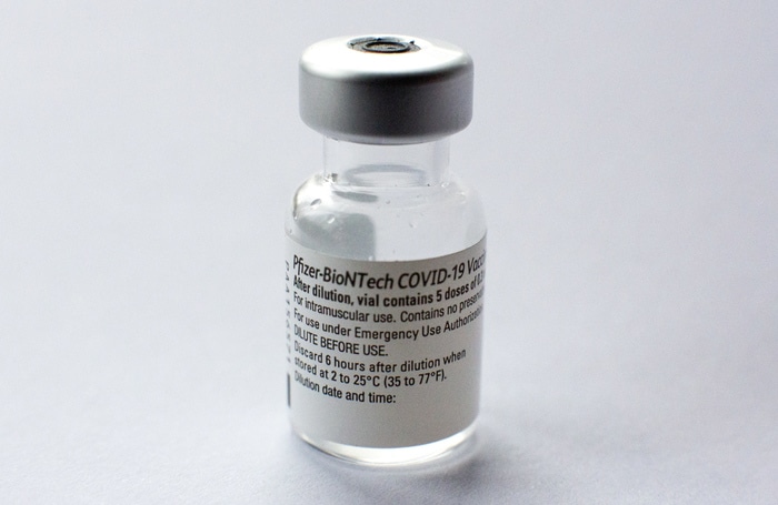epa08980057 A used vial the Pfzer-BioNTech COVID-19 vaccine  in London, Britain 01 February, 2021. The UK government is aiming to offer vaccines to 15 million people - those aged 70 and over, healthcare workers and people required to shield - by mid-February.  EPA/NEIL HALL