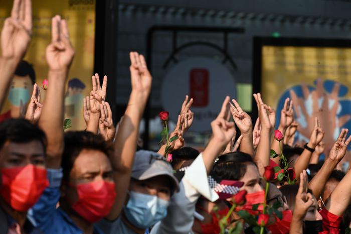 Protesters hold up the three finger salute during a demonstration against the military coup in Yangon on February 7, 2021. (Photo by STR / AFP)
