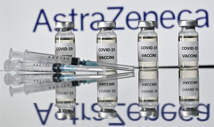 (FILES) In this file photo taken on November 17, 2020 An illustration picture shows vials with Covid-19 Vaccine stickers attached and syringes with the logo of British pharmaceutical company AstraZeneca on November 17, 2020. - The boss of British drugs giant AstraZeneca, which with Oxford University has produced a Covid vaccine, denounced  a 