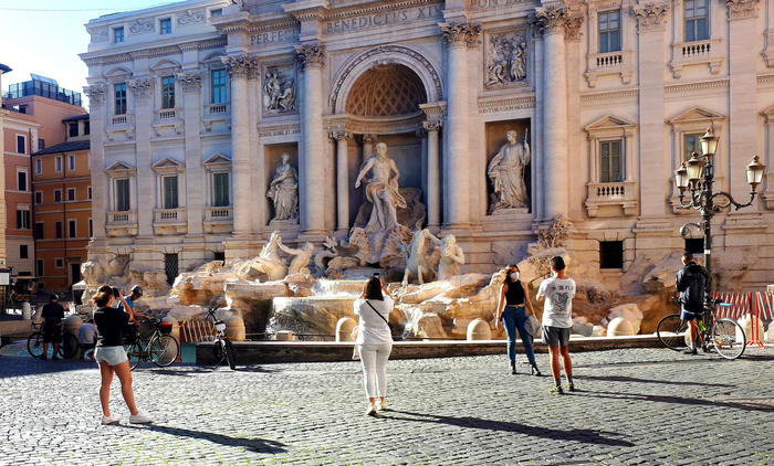 Tourists observe and take photos at the Trevi Fountain during the first day of Coronavirus' emergency Phase 2 in Rome, Italy, 04 May 2020.
ANSA/MARTINO IANNONE