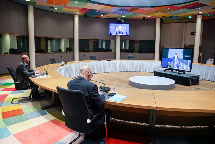epa09067902 President of the European Council Charles Michel (L) looks at a screen at the start of the video conference of inter-institutional actors with the participation of President of the European Commission Ursula von der Leyen, President of the Eurogroup Pachal Donohoe and President of the European Central Bank Christine Lagarde, at the European Council Building in Brussels, Belgium, 11 March 2021. EPA/ARIS OIKONOMOU / POOL