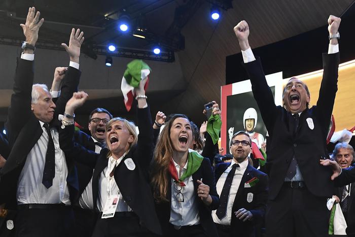 Members of Milan-Cortina delegation celebrate after winning the bid to host the 2026 Winter Olympic Games, during the first day of the 134th Session of the International Olympic Committee (IOC), at the SwissTech Convention Centre, in Lausanne, Switzerland, Monday, June 24, 2019. Italy will host the 2026 Olympics in Milan and Cortina d'Ampezzo, taking the Winter Games to the Alpine country for the second time in 20 years. (Philippe Lopez/Pool via AP)