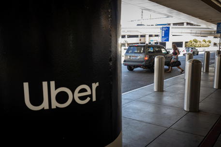 epa08600228 A woman enters a vehicle at an Uber pickup station at the Los Angeles International Airport in Los Angeles, California, USA, 12 August 2020. According to media reports, Uber is considering shuttering operations in California if forced to classify its drivers as employees. Drivers for the ride-hailing service are currently classified as independent contractors. A recent Superior Court ruling demanded the company classify its drivers as employees, as the current classification excludes them from access to workers compensation and health care benefits. Uber has filed an appeal against the ruling.  EPA/CHRISTIAN MONTERROSA