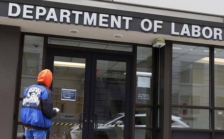 epa08341662 A man looks into the closed offices of the New York State Department of Labor in Brooklyn, New York, USA, on 03 April 2020. The unemployment rate in the United States for March was reported to have risen to 4.4%, according numbers released to day by the U.S. Department of Labor, as the national economy begins to show the large impact from state and city responses to the coronavirus pandemic. New York City is still considered the epicenter of the coronavirus outbreak in the United States and hospital workers dealing with Covid-19 patients are struggling with a limited supply of protective equipment. EPA/JUSTIN LANE