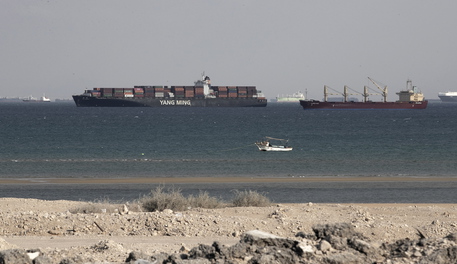 epa09099449 Ships are anchored outside the Suez Canal in Ain Shokhna, near Suez, Egypt, 26 March 2021. The large container ship Ever Given ran aground in the Suez Canal on 23 March, blocking passage of other ships and causing a traffic jam for cargo vessels. The head of the Suez Canal Authority announced on 25 March that 'the navigation through the Suez Canal is temporarily suspended' until the floatation of the Ever Given is completed. Its floatation is being carried out by eight large tugboats that are towing and pushing the grounding vessel.  EPA/KHALED ELFIQI