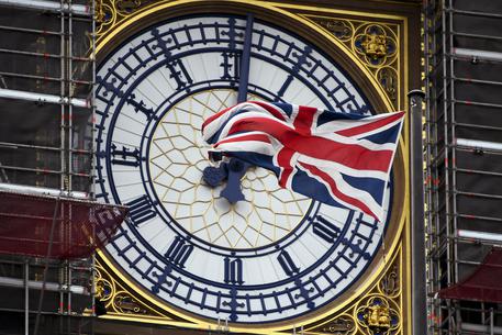 A Union flag waves against the backdrop of the clock facade of the Elizabeth Tower, which holds the bell known as Big Ben, in London, Friday, Nov. 1, 2019. British euroskeptic politician Nigel Farage is trying to ramp up the pressure on Conservative Prime Minister Boris Johnson. He warned that his Brexit Party will run against the Conservatives across the country in the Dec. 12 general election unless Johnson abandons his divorce deal with the European Union.  (ANSA/AP Photo/Alberto Pezzali) [CopyrightNotice: Copyright 2019 The Associated Press. All rights reserved]