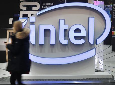 epa05859235 A woman passes an Intel logo at the CeBIT computing trade fair in Hanover, northern Germany, 20 March 2017. Reports state that more than 3.000 exhibitors from 70 countries are showing their products and solutions at the fair which expects to see about 200.000 visitors from 20 to 24 March 2017.  EPA/FOCKE STRANGMANN