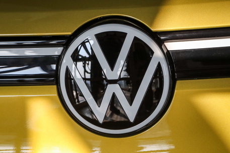epa09098548 A view of a Volkswagen logo on an electric car ID.4 inside one of the car towers at the Volkswagen Autostadt Wolfsburg, Germany, 26 March 2021. German car maker Volkswagen starts the delivery of its new ID.4 electric car in Germany.  EPA/FOCKE STRANGMANN