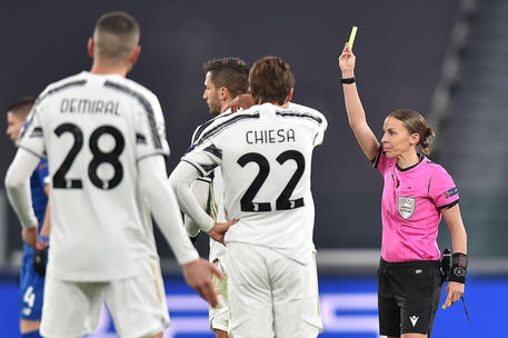 French referee Stephanie Frappart shows a yellow card during the Uefa Champions League soccer match Juventus FC vs FK Dynamo Kyiv at the Allianz Stadium in Turin, Italy, 2 December 2020 ANSA/ALESSANDRO DI MARCO