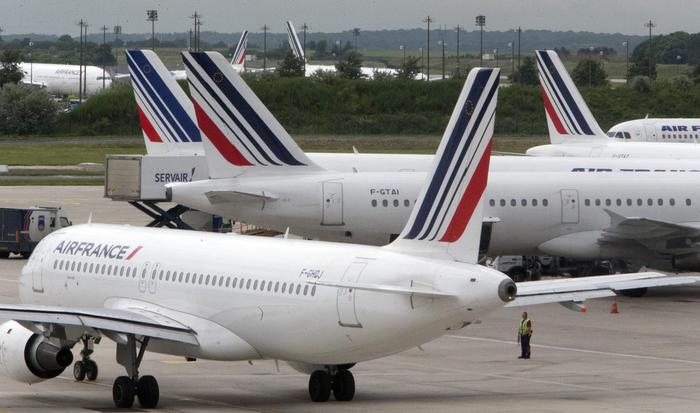 FILE -  This Thursday, June 13, 2013 file photo shows Air France planes parked on the tarmac at Roissy Charles de Gaulle airport near Paris, France, during an air traffic controllers strike. Air France has cancelled 10 percent of its long-distance flights Friday due to a strike by cabin crew amid mass departures for summer vacation. (ANSA/AP Photo/Jacques Brinon, File)