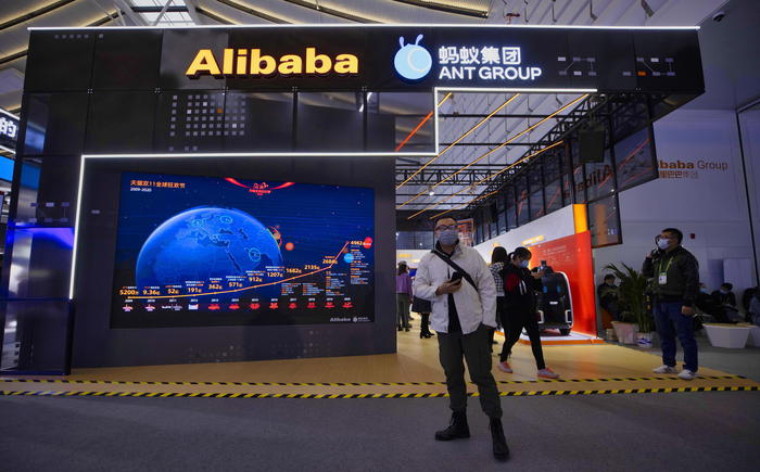 epa08837169 People walk in front of the Alibaba and Ant Group booth on Â“Light Of The Internet ExpoÂ” during World Internet Conference in Wuzhen, Zhejiang Province, China, 23 November 2020. The World Internet Conference, also known as Wuzhen Summit is a two day conference held on 23 to 24 November.  EPA/ALEX PLAVEVSKI