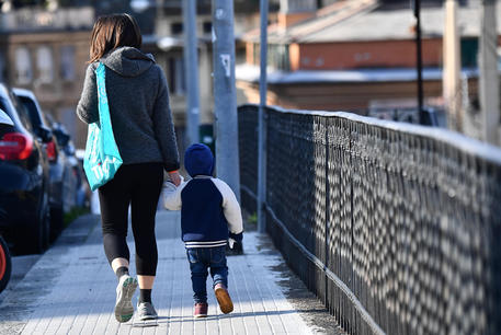 One of the very few mothers with her baby traveling around the city, Genova, Italy, 30 March 2020. Countries around the world are taking measures to stem the widespread of the SARS-CoV-2 coronavirus which causes the Covid-19 disease. ANSA/LUCA ZENNARO