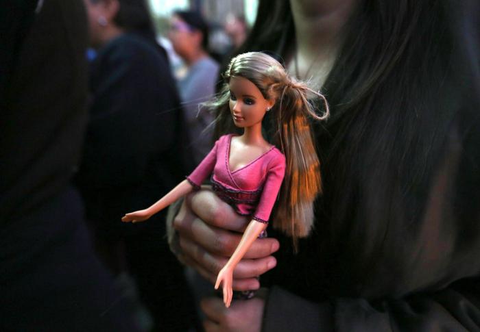 epa07424511 (FILE) - A woman holds a Barbie doll in Guatemala City, Guatemala, 09 March 2017 (reissued 09 March 2019). The Barbie doll celebrates its 60th anniversary, after the debut at the New York Toy Fair on 09 March 1959.  EPA/ESTEBAN BIBA
