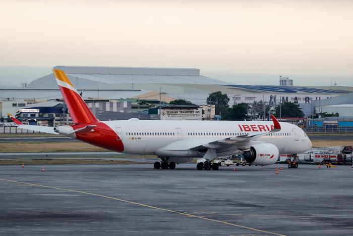 epa08379234 A view of an Iberia airline plane parked at the Ninoy Aquino International Airport terminal 1 in Paranaque, Manila, Philippines, 23 April 2020. Almost 200 Spanish nationals coming from different provinces from the Philippines were repatriated through a chartered flight by the Spanish government amid the coronavirus pandemic.  EPA/MARK R. CRISTINO