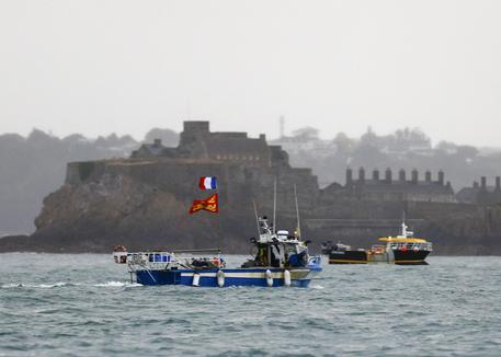 ALTERNATIVE CROP - French fishing boats protest in front of the port of Saint Helier off the British island of Jersey to draw attention to what they see as unfair restrictions on their ability to fish in UK waters after Brexit, on May 6, 2021. - Around 50 French fishing boats gathered to protest at the main port of the UK island of Jersey on May 6, 2021, amid fresh tensions between France and Britain over fishing. The boats massed in front of the port of Saint Helier to draw attention to what they see as unfair restrictions on their ability to fish in UK waters after Brexit, an AFP photographer at the scene said. (Photo by Sameer Al-DOUMY / AFP) / ALTERNATIVE CROP