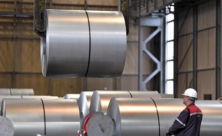 FILE - In this April 27, 2018 photo a worker moves steel coils at the Thyssenkrupp steel factory in Duisburg, Germany.  (ANSA/AP Photo/Martin Meissner, file) [CopyrightNotice: Copyright 2018 The Associated Press. All rights reserved.]