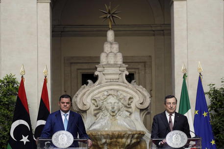 epa09239407 Italian Prime Minister Mario Draghi (R) and Libyan Prime Minister Abdulhamid Al Dabaiba deliver their statements at the end of their meeting at Chigi palace, in Rome, Italy, 31 May 2021. Dabaiba is visiting Rome for talks with Draghi and attending business forum, where the two sides will discuss cooperation in oil exploration and production, health sector and the fight against COVID19 as well as construction efforts in Libya.  EPA/GREGORIO BORGIA / POOL