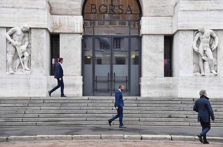 A financial consultants outside the Stock Exchange on Piazza Affari in Milan, Italy,  11 October 2018.  Milan's Piazza Affari pens down and yields 1.27% to 19.469 points.  ANSA/DANIEL DAL ZENNARO