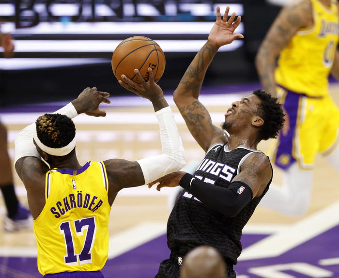 epa09112790 Los Angeles Lakers guard Dennis Schroder of Germany (L) fouls Sacramento Kings guard Delon Wright (R) during the second half of the NBA basketball game between Los Angeles Lakers aand the Sacramento Kings the at Golden 1 Center in Sacramento, California, USA, 02 April 2021.  EPA/JOHN G. MABANGLO SHUTTERSTOCK OUT