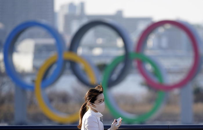 A young woman walks past an Olympic rings monument at Odaiba Marine Park in Tokyo, Japan, 11 February 2021. Tokyo 2020 Olympic Games Organising Committee President Yoshiro Mori is to step down following the turmoil caused by the sexist remarks he made on 03 February during a Japanese Olympic Committee meeting.  ANSA/FRANCK ROBICHON