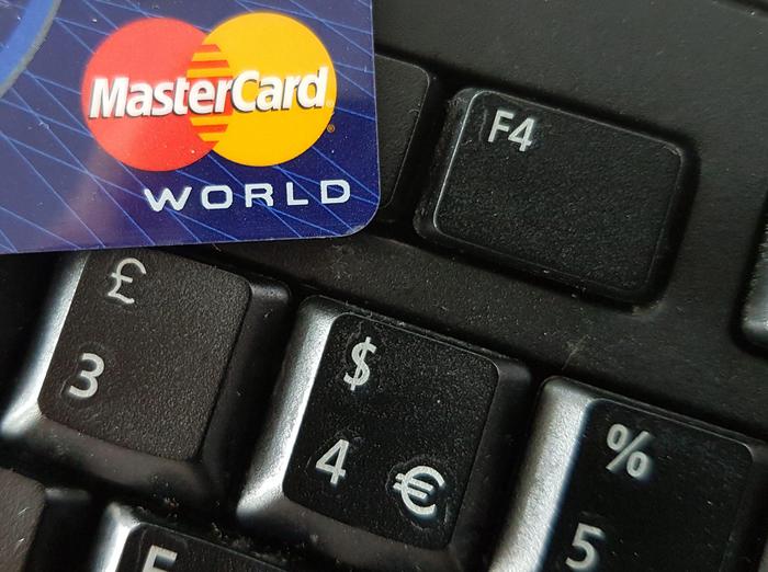 epa05533346 A close-up image showing a Mastercard credit card on a computer keyboard with British pound, US dollar and euro symbols, Frankfurt, Germany, 10 September 2016. Media reports state Mastercard has been sued by Quinn Emanuel law firm in Britain for 14 billion pounds (19 billion USD) in damages. The company was sued in possibly the largest such damages claim in the history of UK amid allegations it charged stores too much to process credit and debit card payments. Mastercard has denied any such claim and said they 'intend to oppose it vigorously'.  EPA/MAURITZ ANTIN