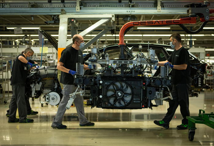 epa08706062 Workers assemble parts during the production of the Seat 'Cupra Formentor', the first exclusive car model of Seat, at Seat's Martorell factory in Barcelona, 29 September 2020. Seat expects to double theirs sales for 2021 with the new Cupra Formentor.  EPA/ENRIC FONTCUBERTA