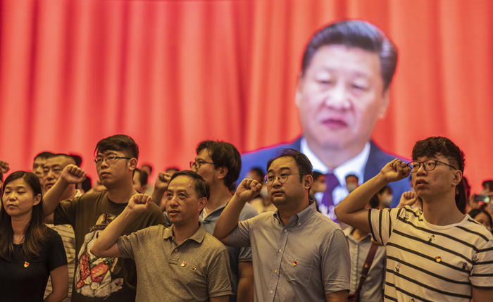 epa09307129 Visitors renew their vows to the Communist Party of China while Chinese President Xi Jinping is seen on a screen behind them at the Memorial of the First National Congress of the Communist Party of China in Shanghai, China, 17 June 2021 (issued 28 June 2021). The memorial was opened in Shanghai this month as the country approaches the centenary of its ruling communist party. China will celebrate the 100th founding anniversary of its ruling Chinese Communist Party (CCP) on 01 July 2021.  EPA/Alex Plavevski