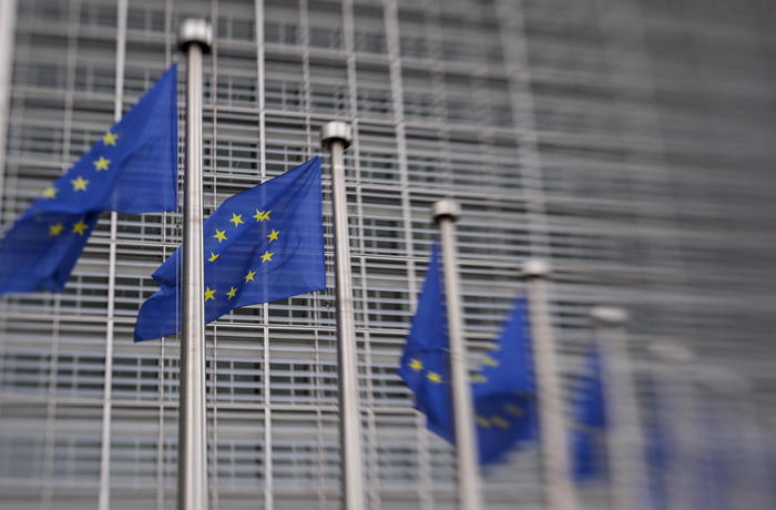 epa09407569 A picture taken with a Lensbaby shows European union flags near the European Commission headquarters, in Brussels, Belgium, 09 August 2021.  EPA/OLIVIER HOSLET